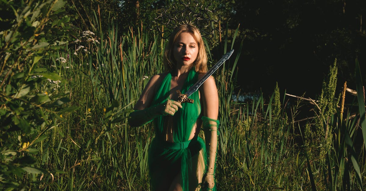 a woman in a green dress holds a sword in a mystical forest setting evoking fantasy themes