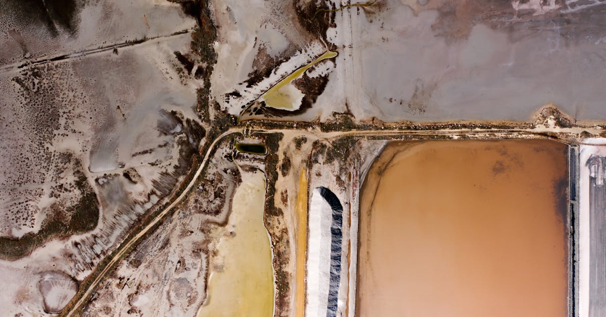 aerial shot of vibrant salt evaporation ponds showcasing colorful mineral rich waters