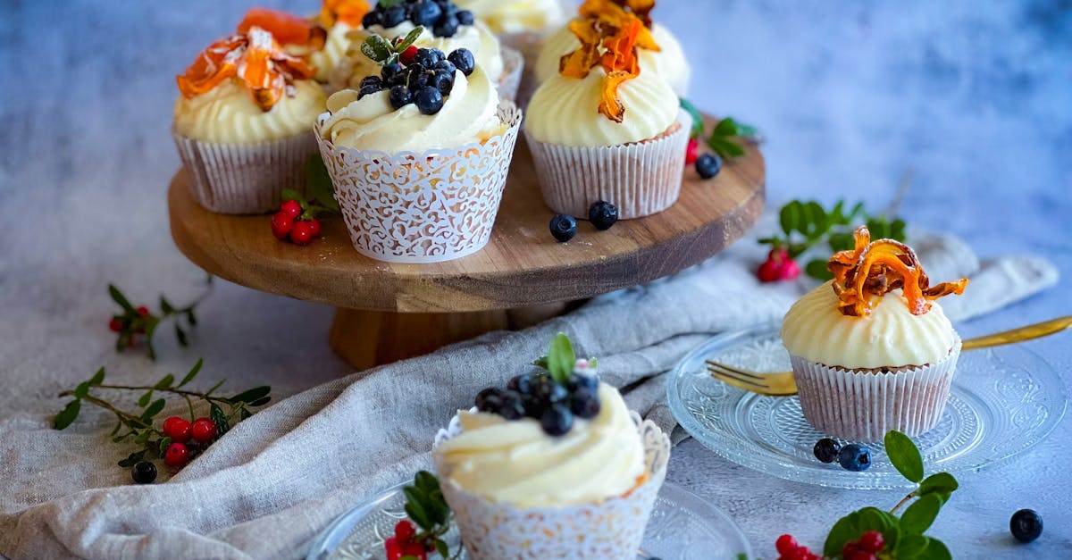 aesthetic cupcakes topped with blueberries on a rustic stand perfect for dessert inspiration