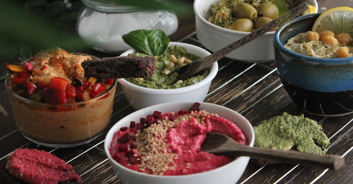 an enticing array of hummus varieties with toppings and colorful garnishes on a wooden table 1