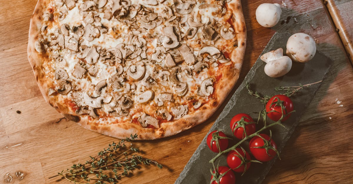 appetizing pizza with mushrooms and tomatoes on rustic wooden table perfect for food enthusiasts