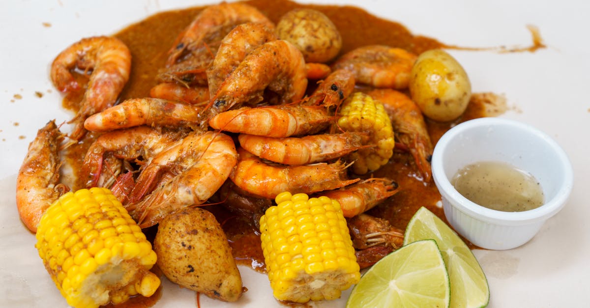 appetizing seafood boil featuring shrimp corn potatoes and lime wedges 1