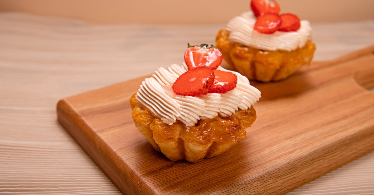 appetizing strawberry tarts with cream cheese on a wooden board perfect for dessert