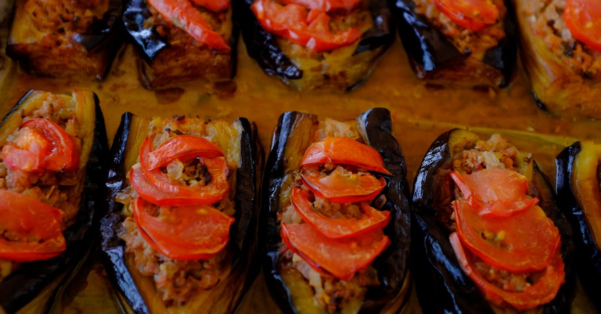baked eggplants stuffed with meat and topped with fresh tomatoes perfect for mediterranean cuisine 2