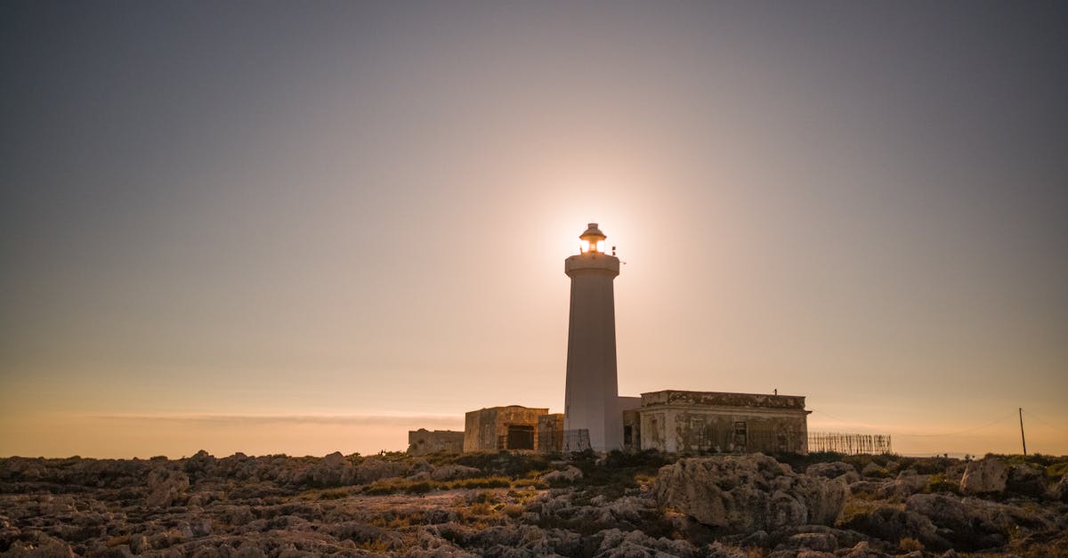 beautiful view of capo murro di porco lighthouse silhouetted against a stunning sunset 1