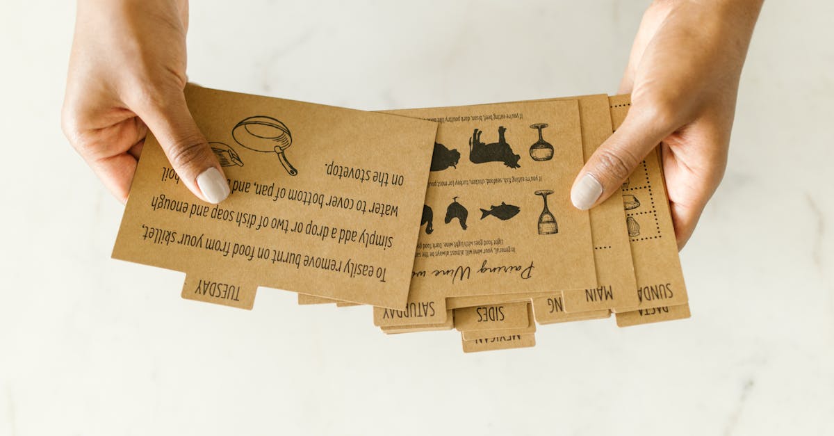 brown kraft paper recipe cards held by hand on light background