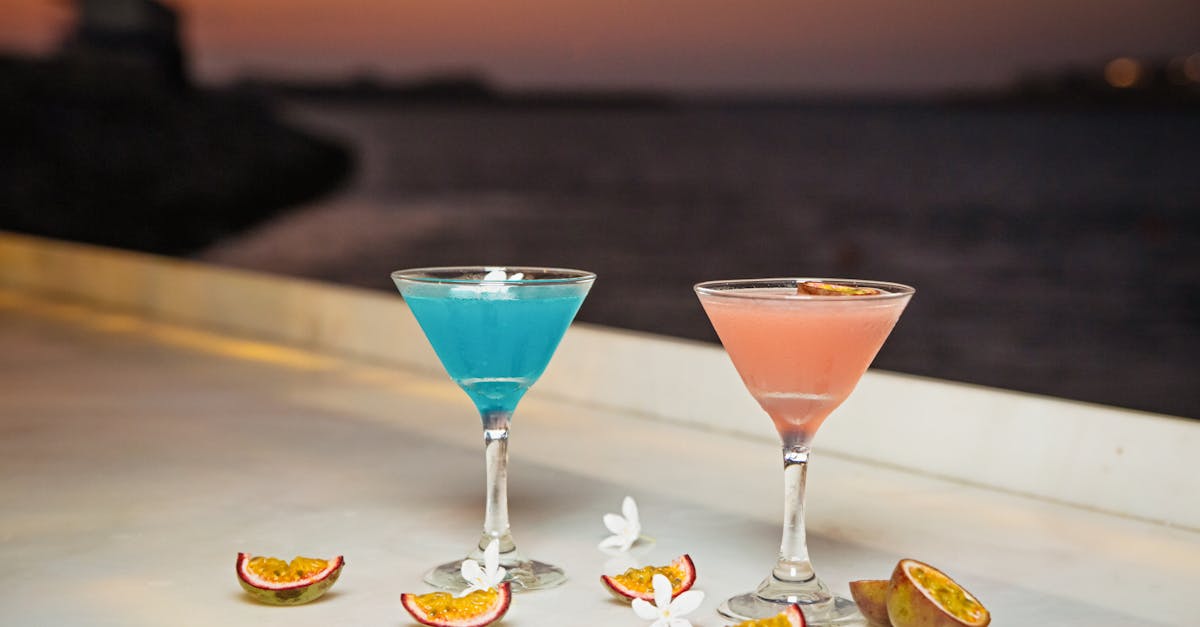 chic martini cocktails by the sea with passion fruit and flowers at sunset in dubai