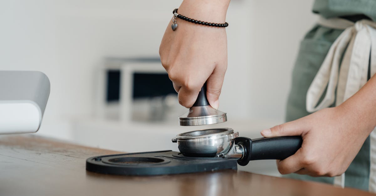 close up of a barista tamping espresso in a portafilter for a fresh brew 2