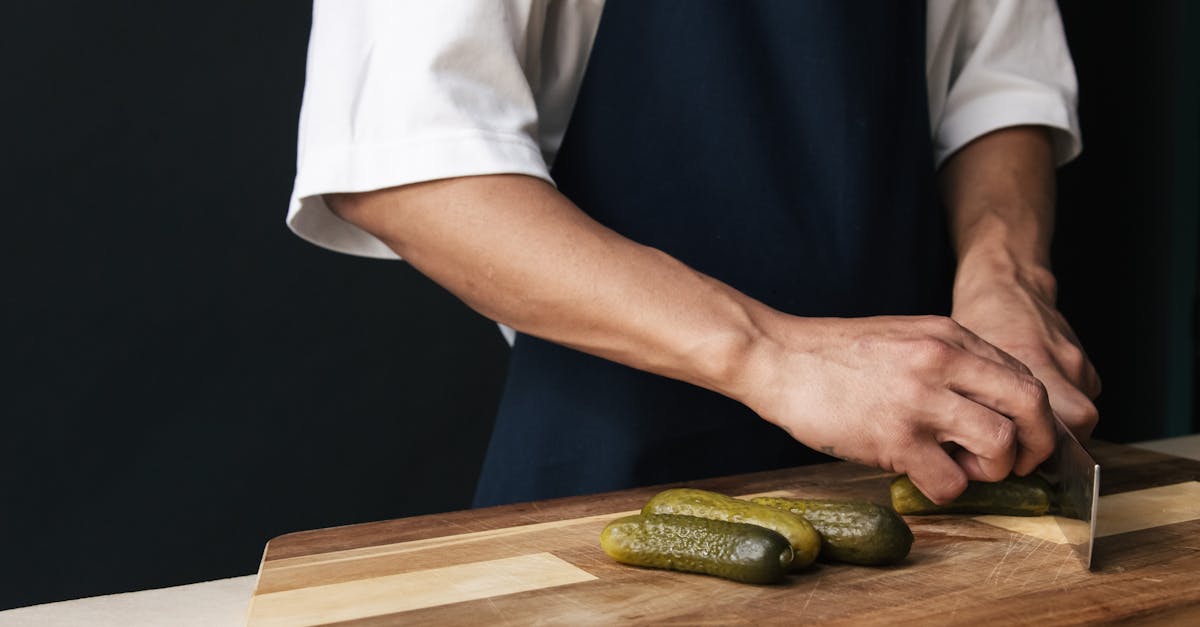close up of a chef cutting pickles on a wooden chopping board perfect for culinary themes 10