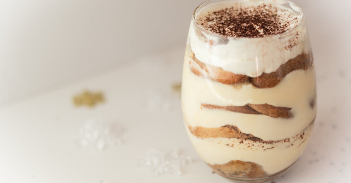 close up of a creamy tiramisu dessert in a glass beautifully presented with cocoa topping perfect 19