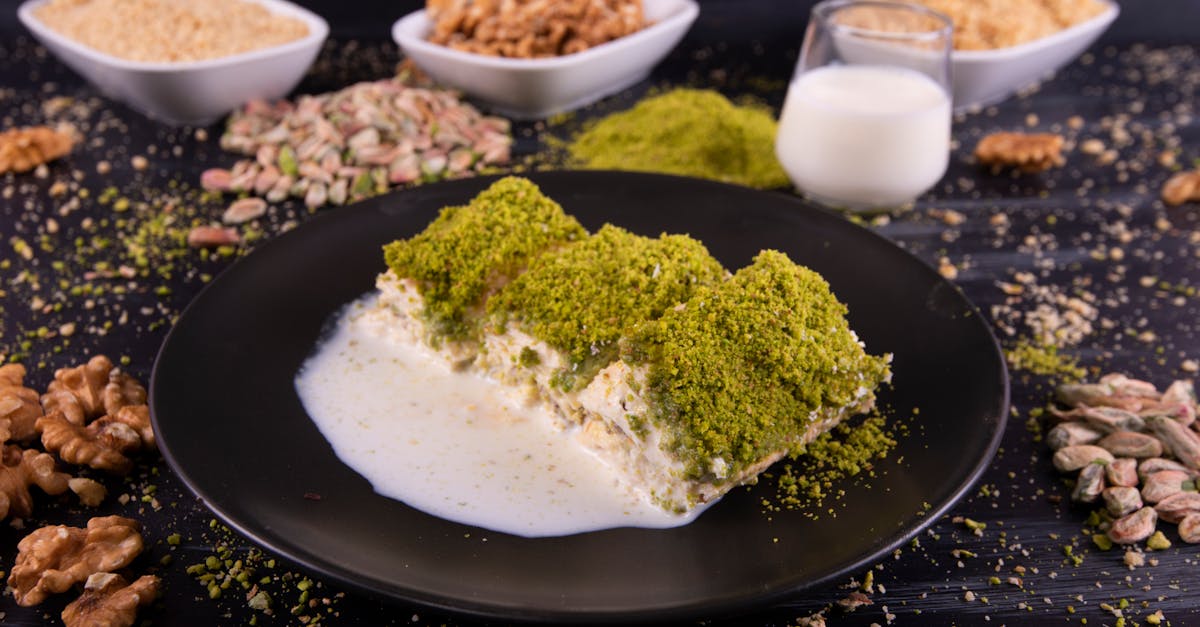 close up of a creamy turkish dessert topped with pistachios served with milk and nuts 1