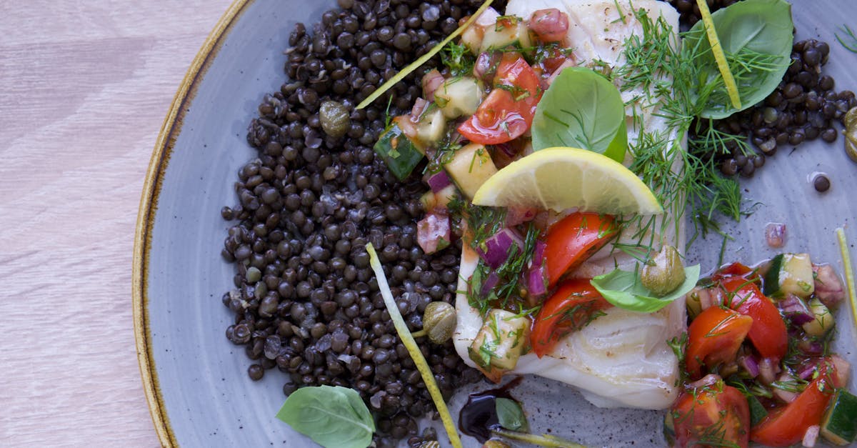 close up of a delicious cod fish dish with lentils salsa and fresh herbs on a plate 8