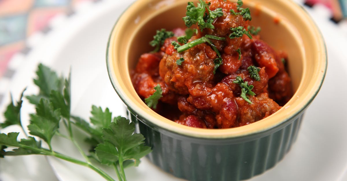 close up of a flavorful homemade chili dish garnished with fresh parsley perfect for a cozy meal