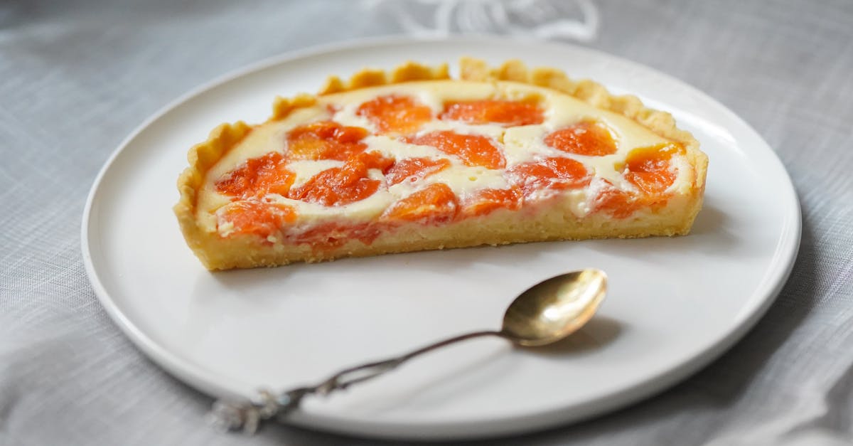 close up of a freshly baked apricot tart slice served on a white plate 22