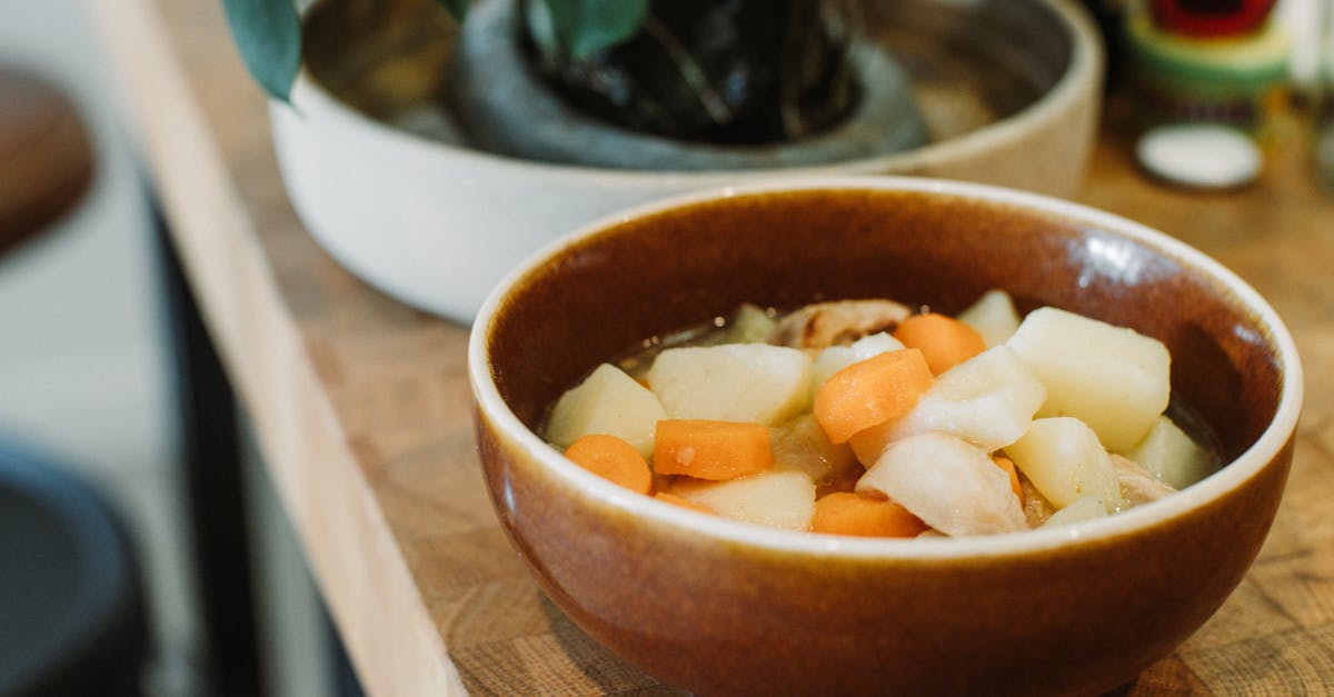 close up of a steaming vegetable stew served in a rustic ceramic bowl on a wooden table 1
