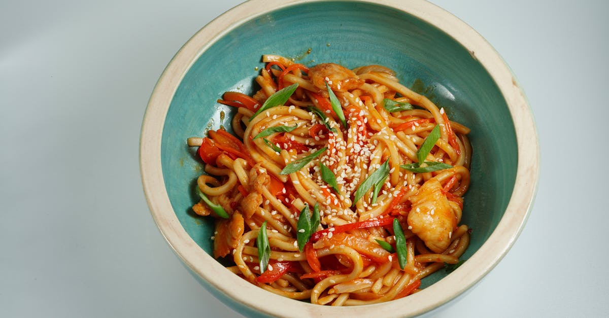 close up of a tasty chicken noodle dish garnished with sesame seeds