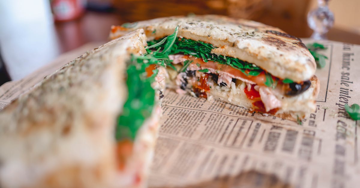 close up of a tuscan schiacciata sandwich with fresh ingredients on a rustic table