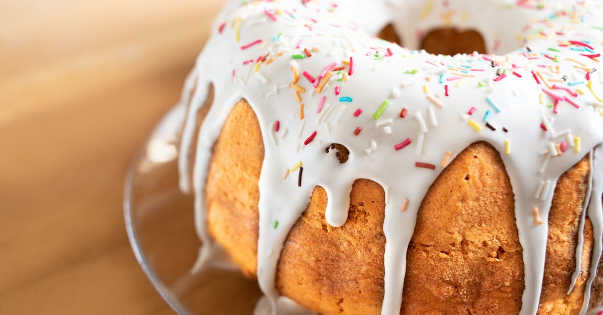 close up of a vanilla bundt cake with white icing and colorful sprinkles perfect dessert treat