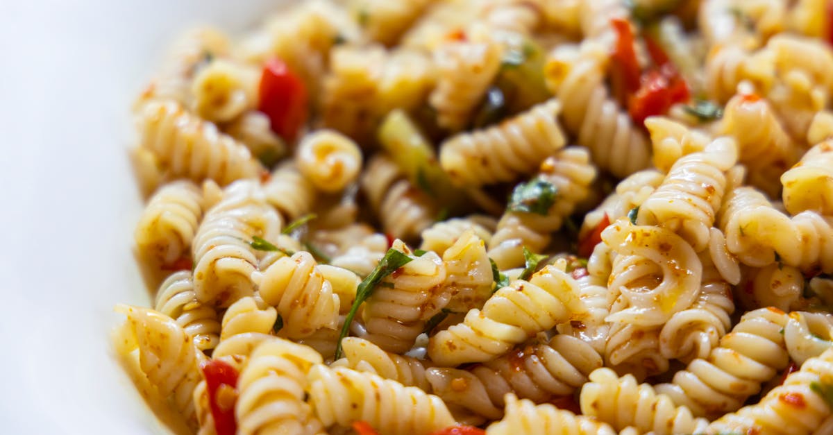close up of a vibrant vegan rotini pasta salad with fresh vegetables
