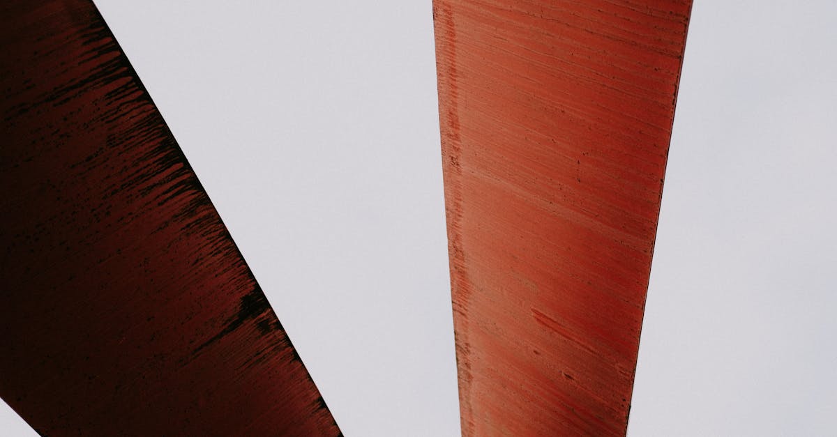 close up of abstract rusty metal structures against a light sky providing a sense of geometric desi
