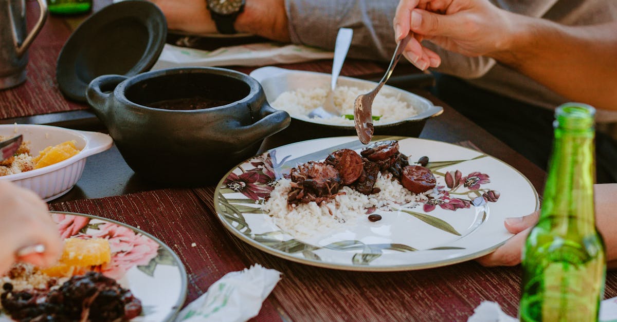 close up of authentic brazilian feijoada served on a table with rice oranges and beverages 9