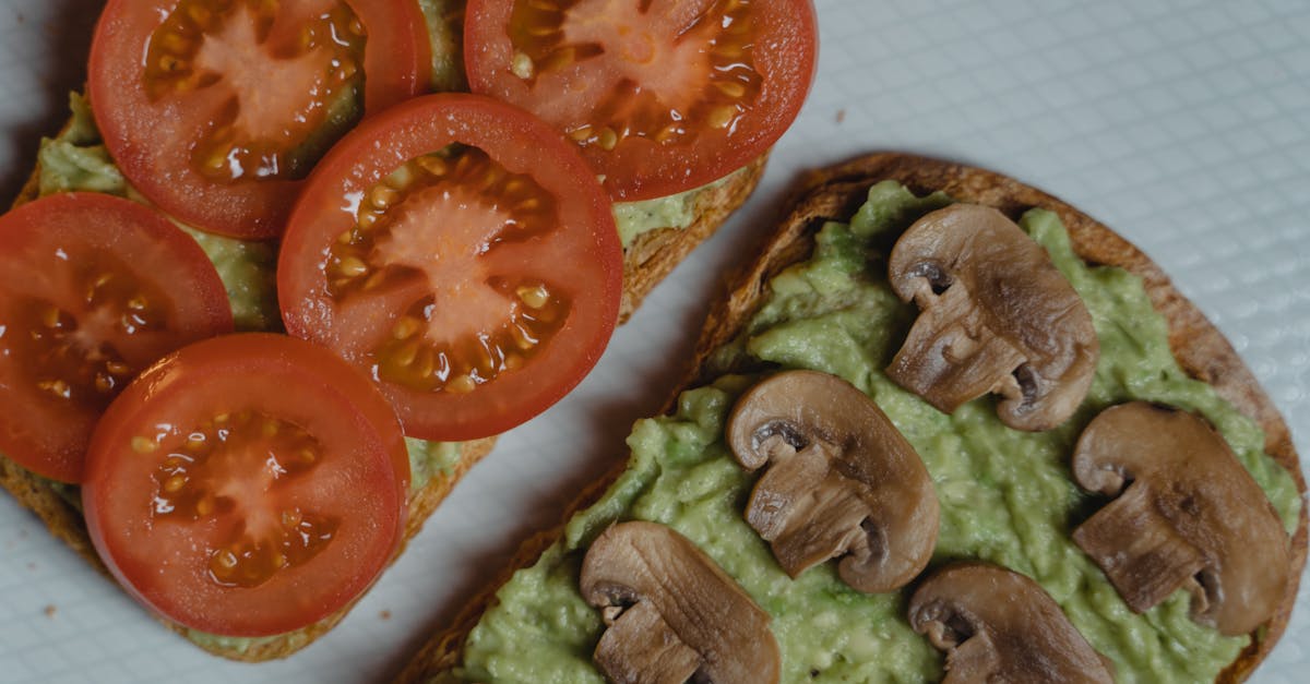 close up of avocado toasts topped with fresh tomatoes and mushrooms a healthy vegan snack 2