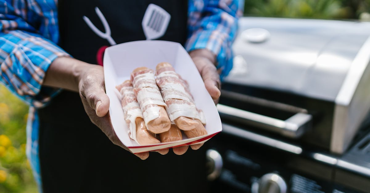 close up of bacon wrapped hotdogs being prepared for grilling perfect for barbecue enthusiasts 6