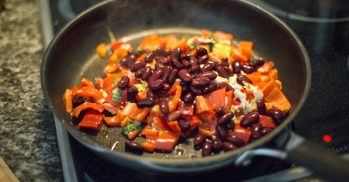 close up of bell peppers and beans in a frying pan on a stove perfect for healthy meal prep