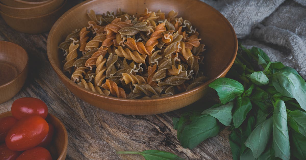 close up of colorful fusilli pasta with basil and tomatoes perfect for italian cooking