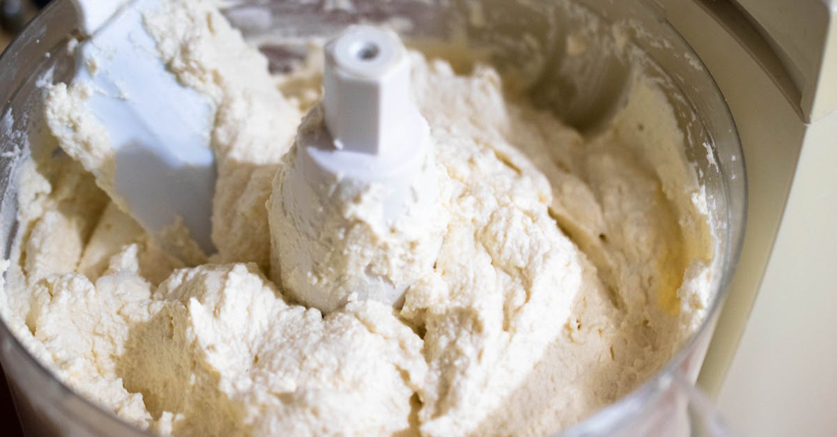 close up of creamy cheese batter being mixed in a food processor perfect for baking needs 2