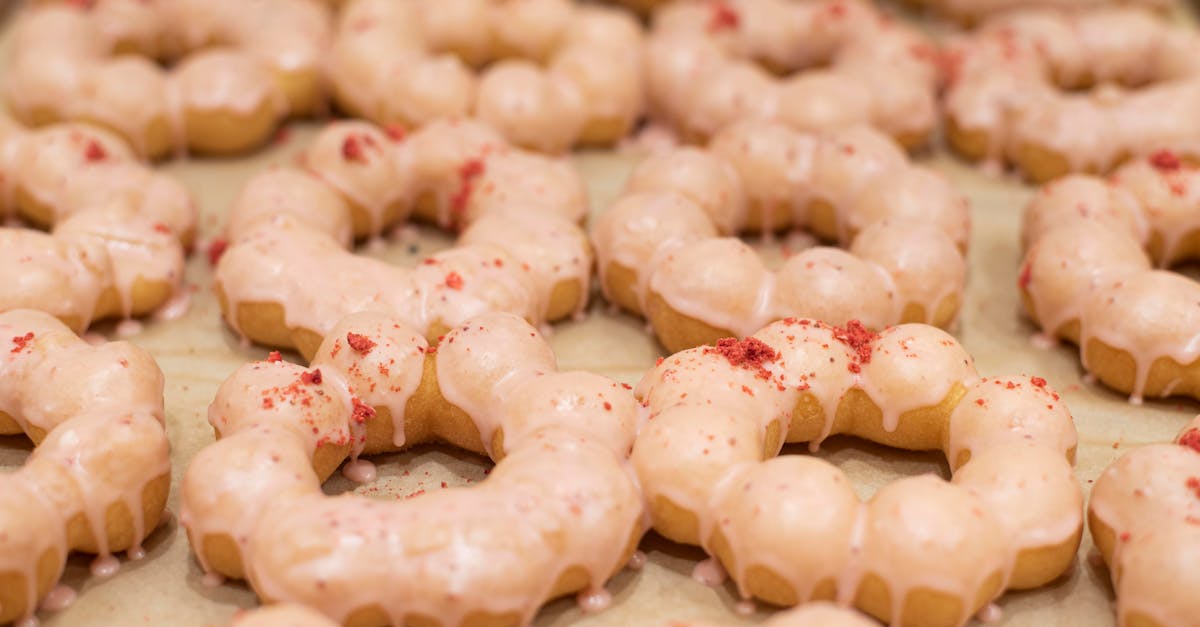 close up of delicious glazed mochi donuts topped with strawberry pieces offering a sweet treat deli