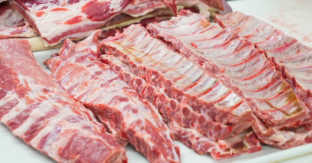 Home close up of fresh raw pork ribs neatly arranged on a cutting board showcasing marbling 8