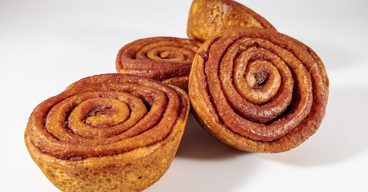 close up of freshly baked cinnamon rolls on a white background ready to eat