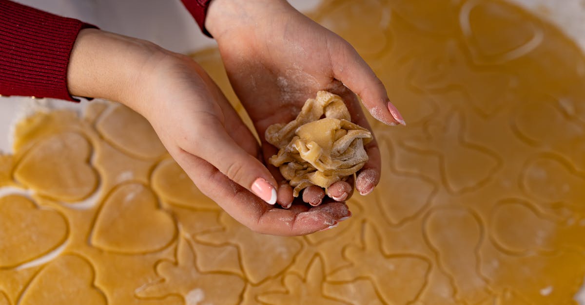 close up of hands crafting dough with heart shapes perfect for baking enthusiasts