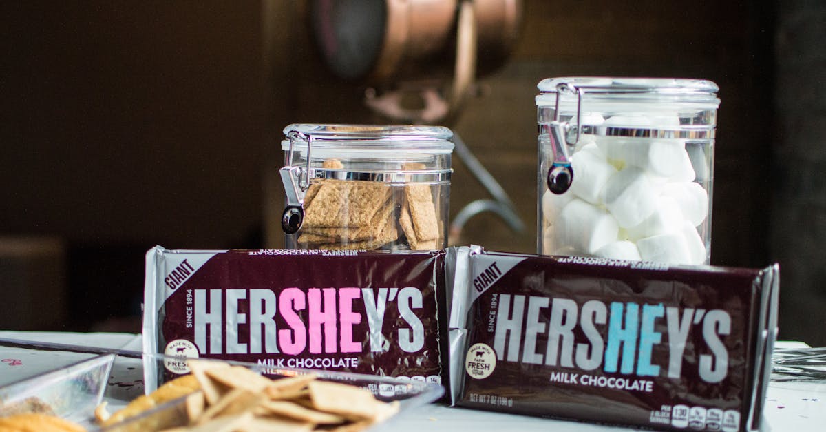 close up of hershey s chocolate bars with jars of graham crackers and marshmallows for delicious s m 5