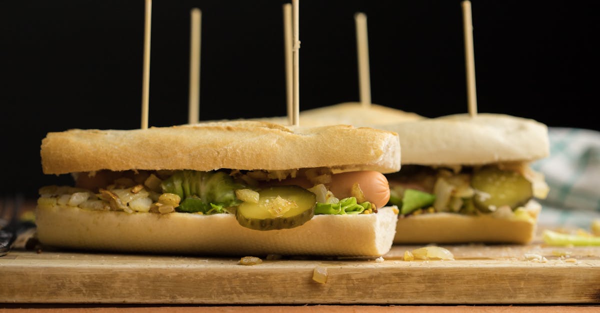 close up of hot dog sandwiches with vibrant toppings on a wooden board
