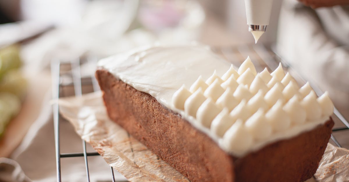 close up of icing being applied to a loaf cake capturing the art of baking 4