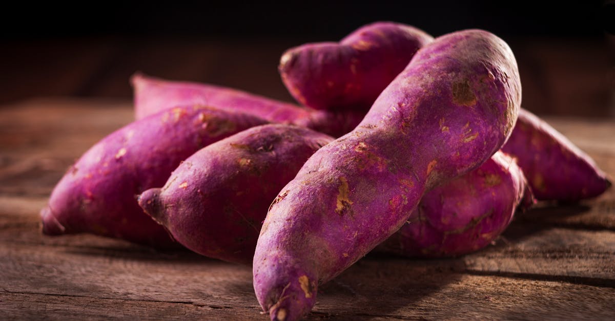 close up of purple sweet potatoes on a wooden surface perfect for culinary and natural food themes 8