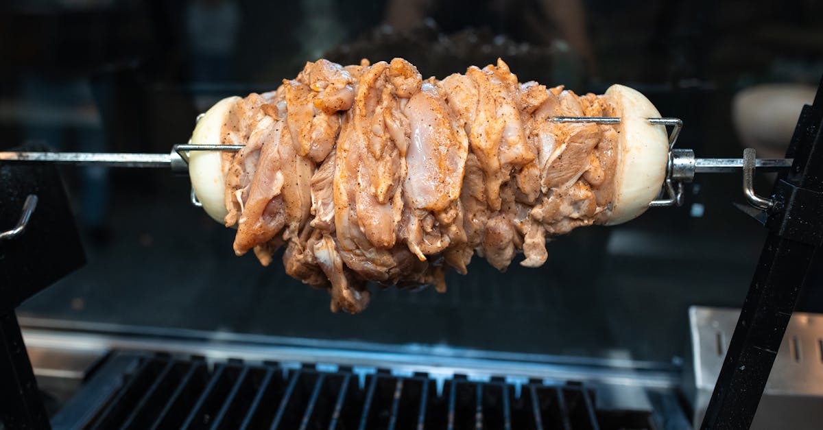 close up of raw chicken shawarma being grilled on a skewer ready for cooking 3