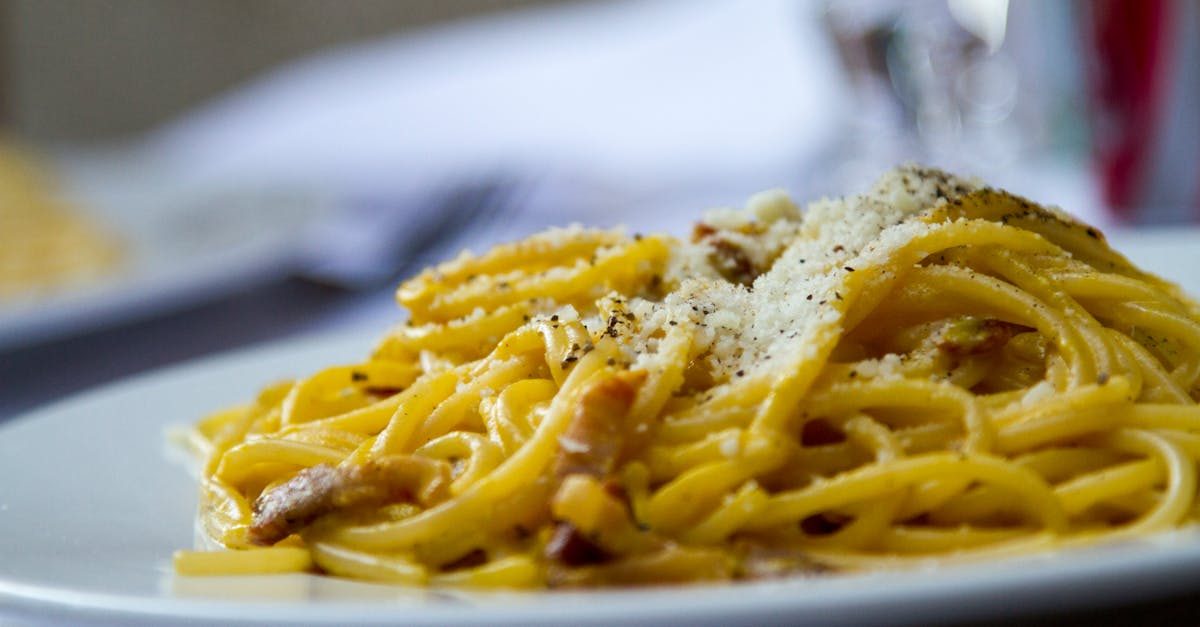 close up of spaghetti carbonara topped with grated parmesan cheese on a plate perfect for italian c 5