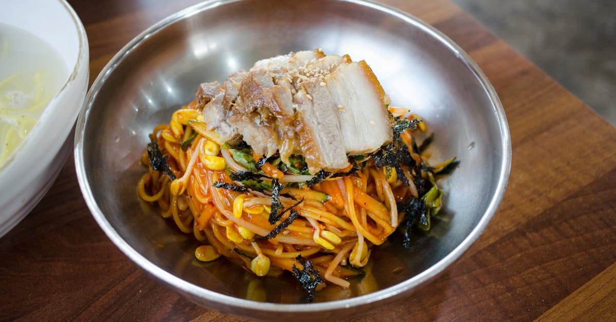 close up of spicy pork noodles with bean sprouts and seaweed capturing the vibrant colors and