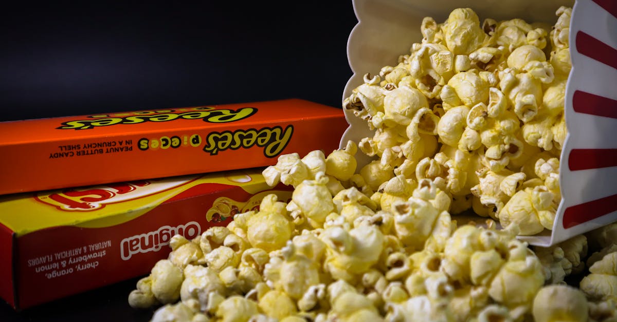 close up of spilled popcorn and candy boxes perfect for snacks or movie night imagery