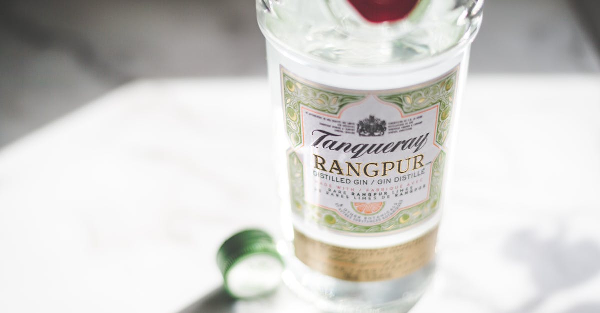 Home close up of tanqueray rangpur gin bottle with cap in sunlight highlighting its label design
