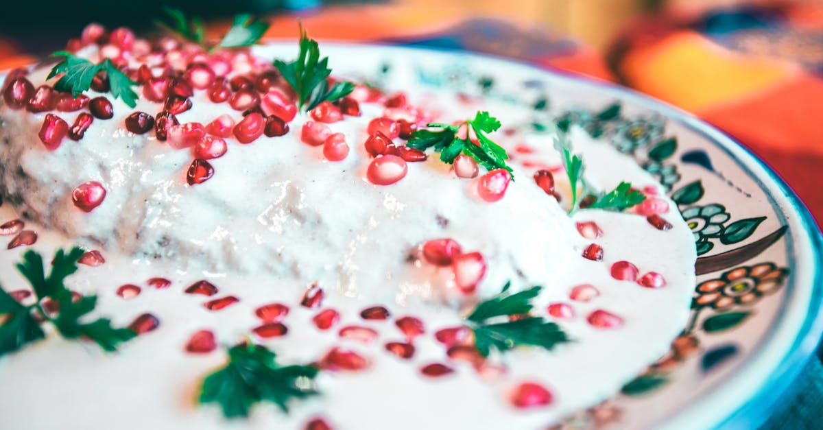 close up of traditional mexican chiles en nogada garnished with pomegranate and parsley 2