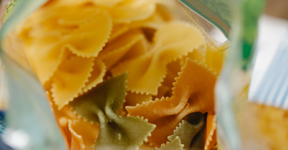 close up shot of colorful uncooked farfalle pasta showcasing its vibrant colors and rustic