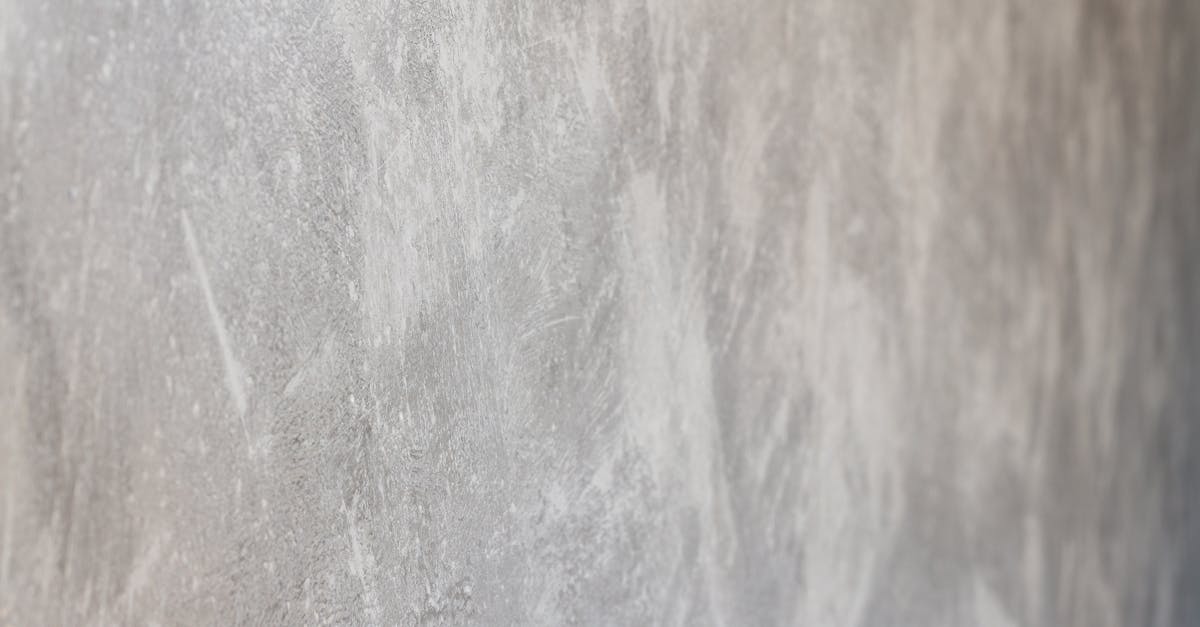 close up view of a textured concrete wall surface with natural patterns