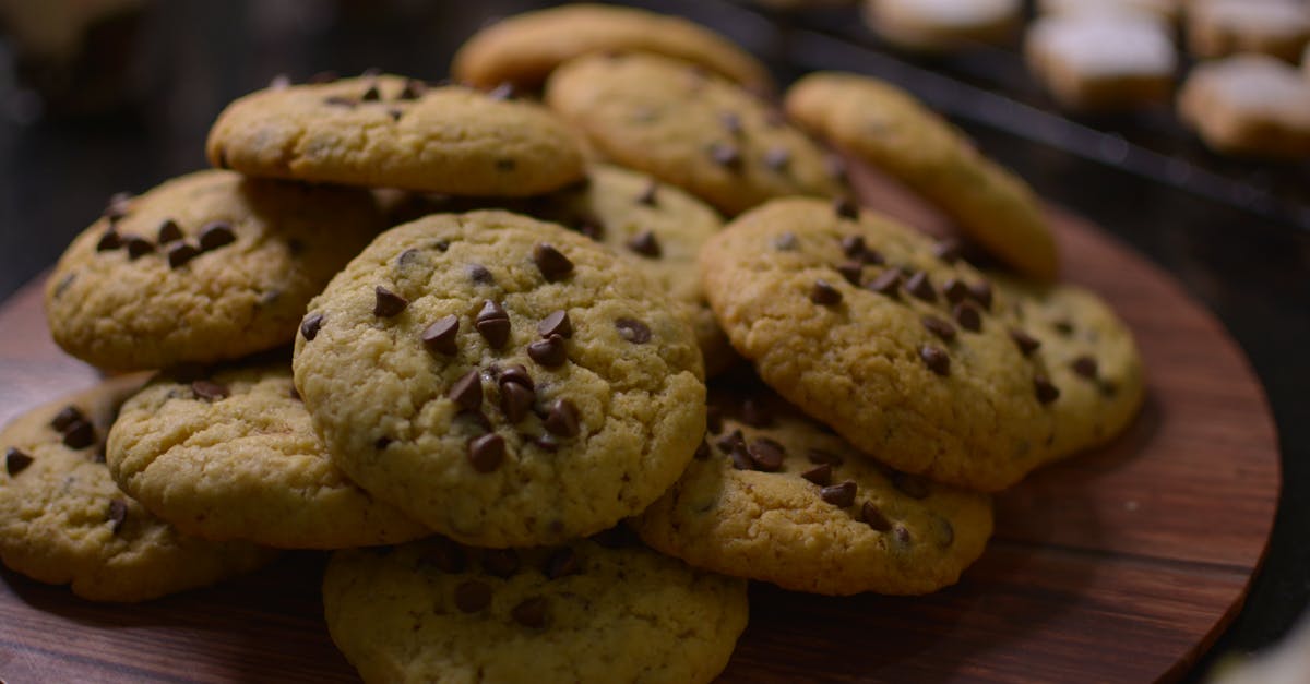 close up view of freshly baked chocolate chip cookies on a wooden tray 1