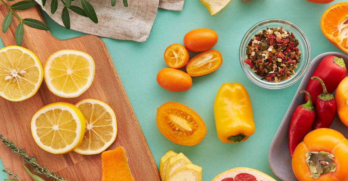 colorful assortment of sliced fruits and vegetables on teal background showcasing freshness 4