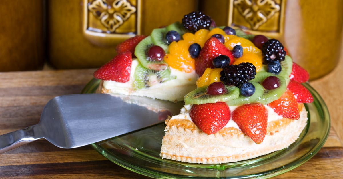 colorful fruit tart with strawberries kiwis and berries on wooden table 1