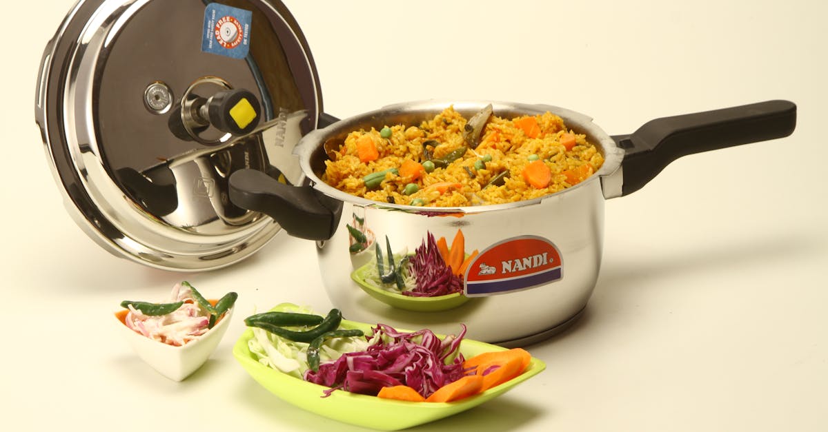 colorful vegetable biryani cooked in a stainless steel pressure cooker with fresh ingredients